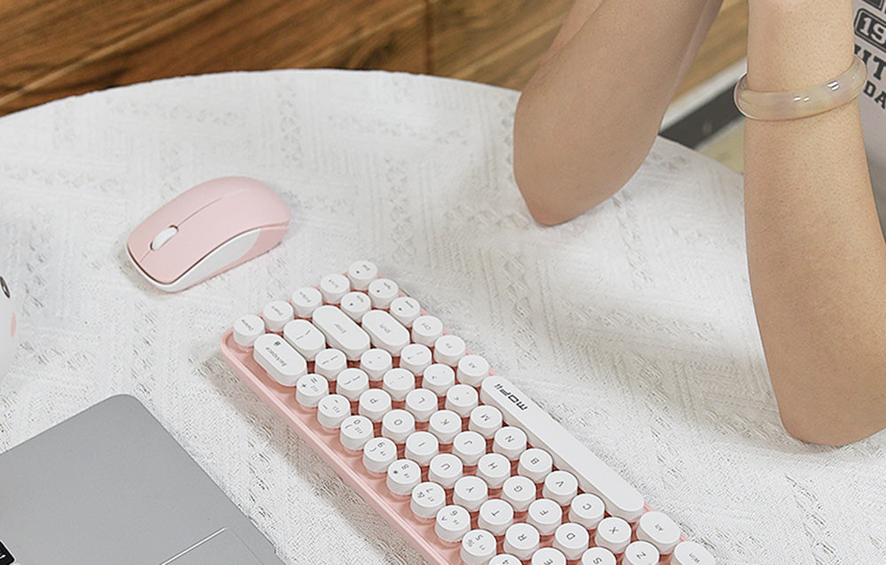 MOFII Bean 2.4G 1200 DPI wireless optical mouse in pink next to compact keyboard on desk
