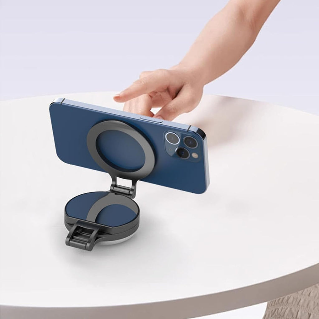 Magnetic fill light attached to a MagSafe phone, folding flat as a stand on a table