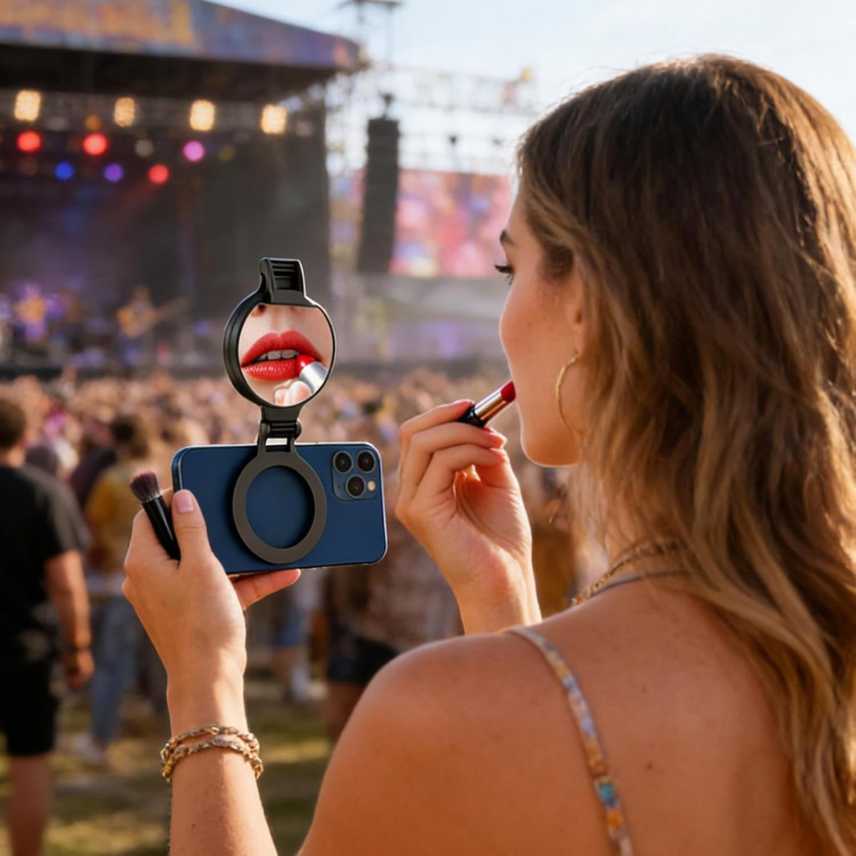 Woman using the phone fill light's built-in mirror to apply makeup outdoors