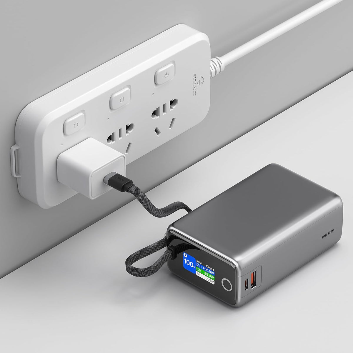 Green Lion Tron X power bank charging laptop via USB-C cable.
