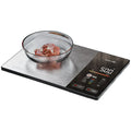 Digital kitchen scale with a bowl of food on a white background