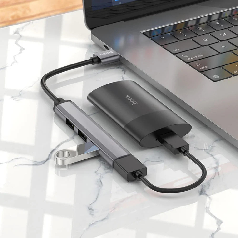 HOCO HB26 USB hub connected to laptop four ports in use