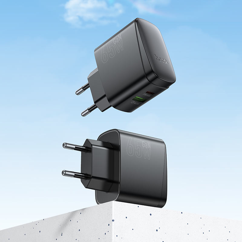 Close-up of HOCO CS63A charger showing dual USB ports and PD65W output.

